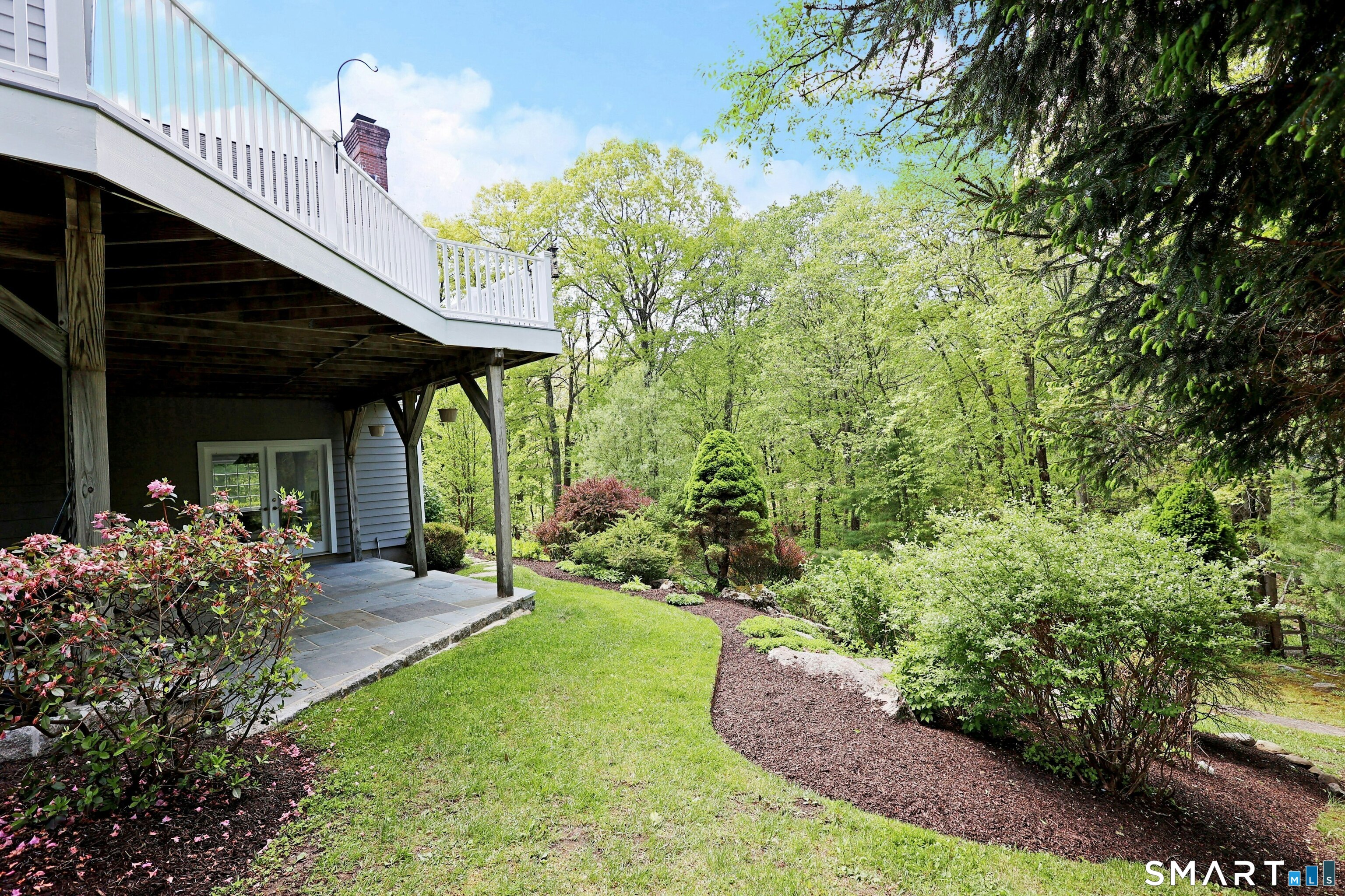 30 Whipstick Road Ridgefield, CT 06877 - Photo 6 of 40 a view of a chair and table in backyard of the house