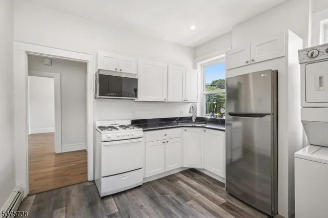 a kitchen with a refrigerator stove and microwave