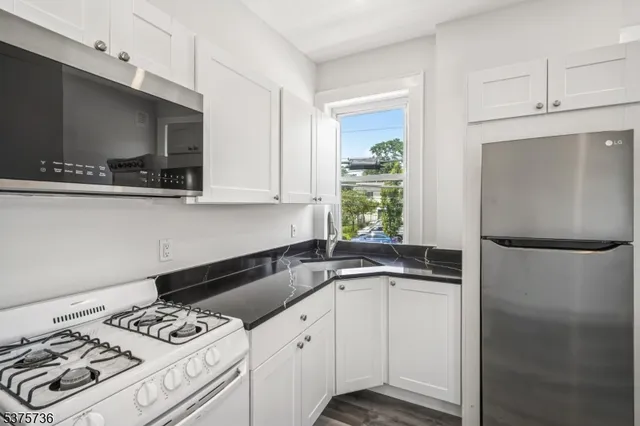 a kitchen with a sink a stove and a refrigerator