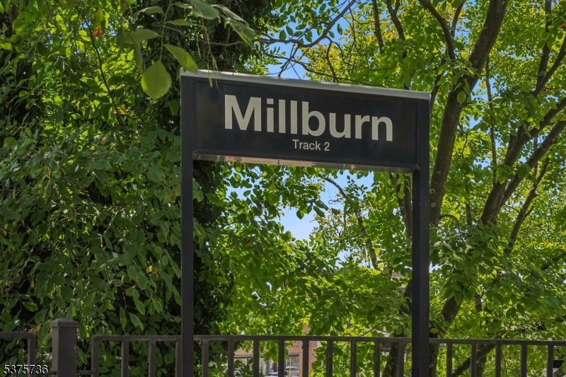 34 Main Street Millburn, NJ 07041 - Photo 17 of 23 a sign broad in front of the red tree
