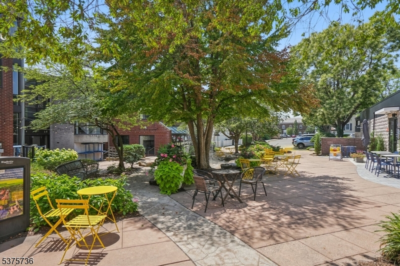 34 Main Street Millburn, NJ 07041 - Photo 23 of 23 a view of a patio with table and chairs potted plants and large tree