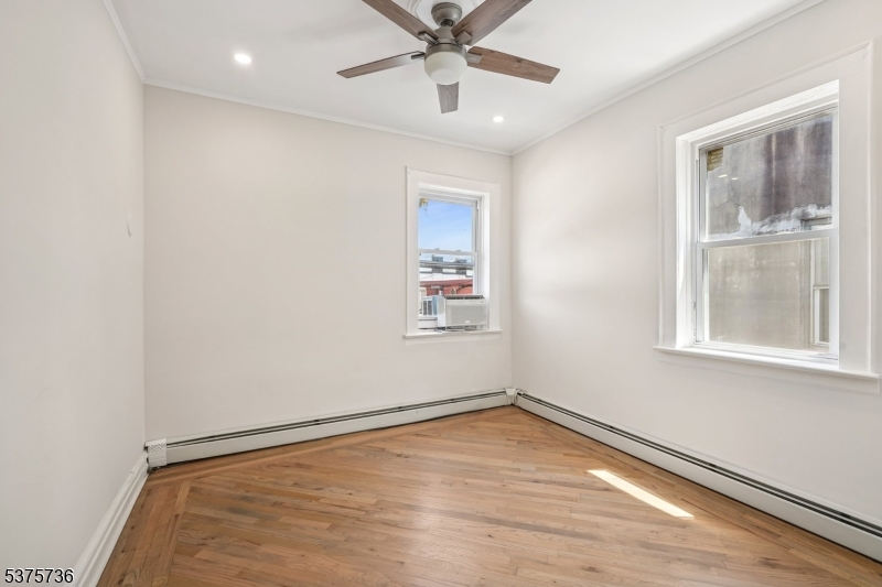 34 Main Street Millburn, NJ 07041 - Photo 7 of 23 an empty room with a window and ceiling fan
