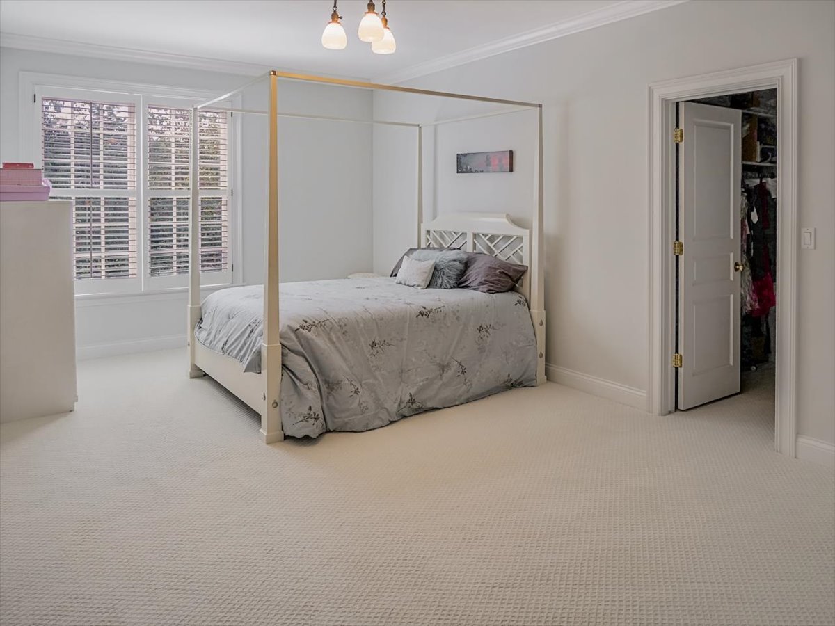 8010 Greenbriar Court Burr Ridge, IL 60527 - Photo 19 of 57 a spacious bedroom with a bed and a window