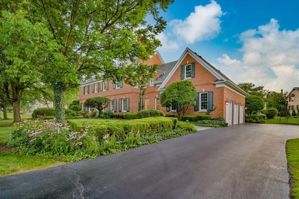 8010 Greenbriar Court Burr Ridge, IL 60527 - Photo 2 of 57 a front view of a house with a yard and trees