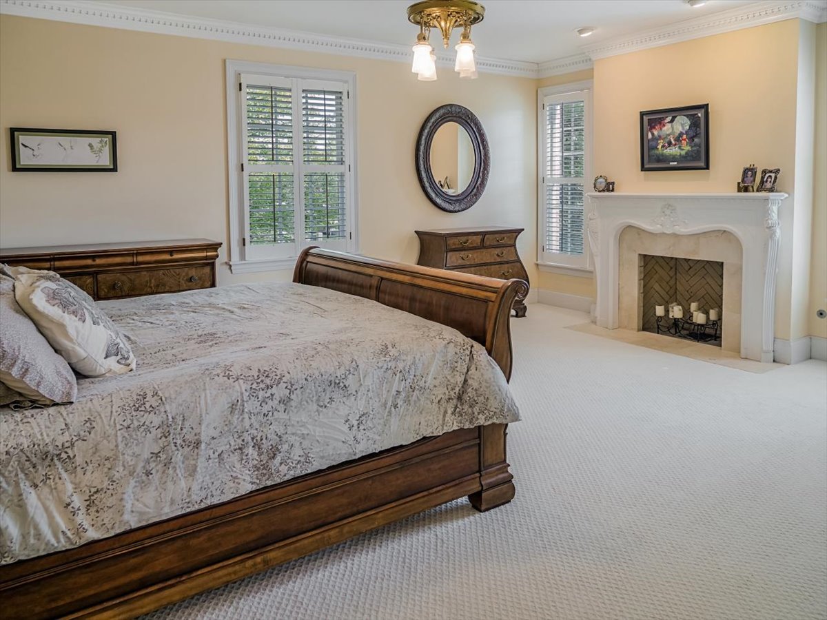 8010 Greenbriar Court Burr Ridge, IL 60527 - Photo 25 of 57 a bedroom with a bed and a fireplace