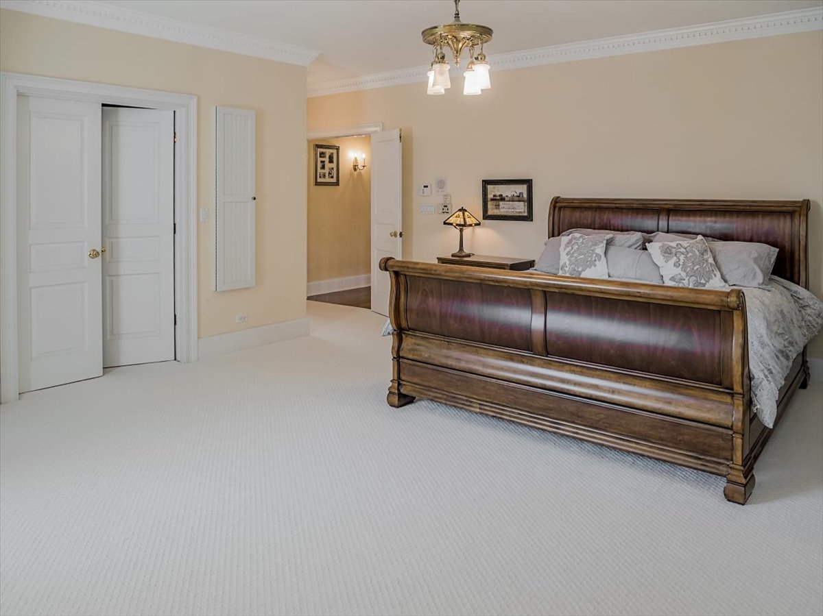 8010 Greenbriar Court Burr Ridge, IL 60527 - Photo 27 of 57 a bedroom with a bed and ceiling fan