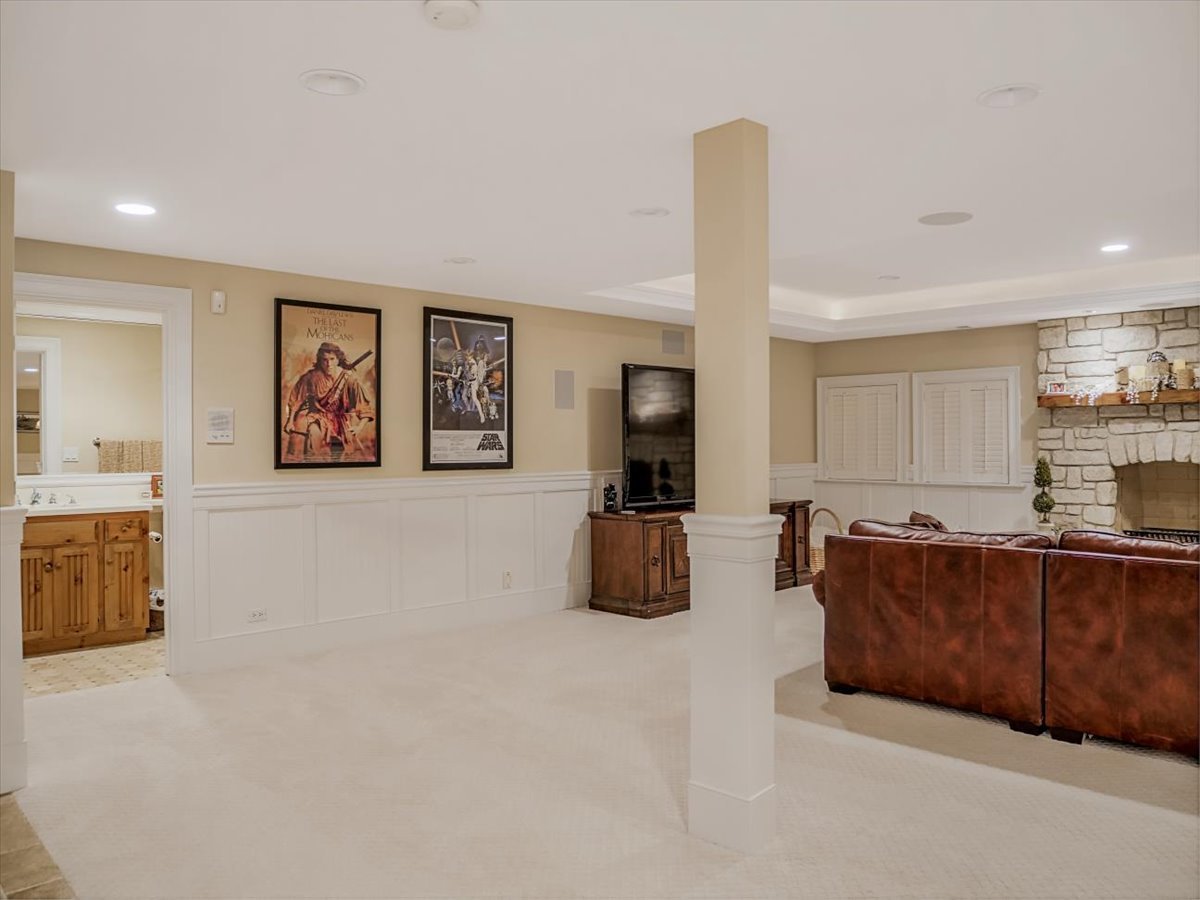 8010 Greenbriar Court Burr Ridge, IL 60527 - Photo 35 of 57 a living room with furniture a flat screen tv and kitchen view