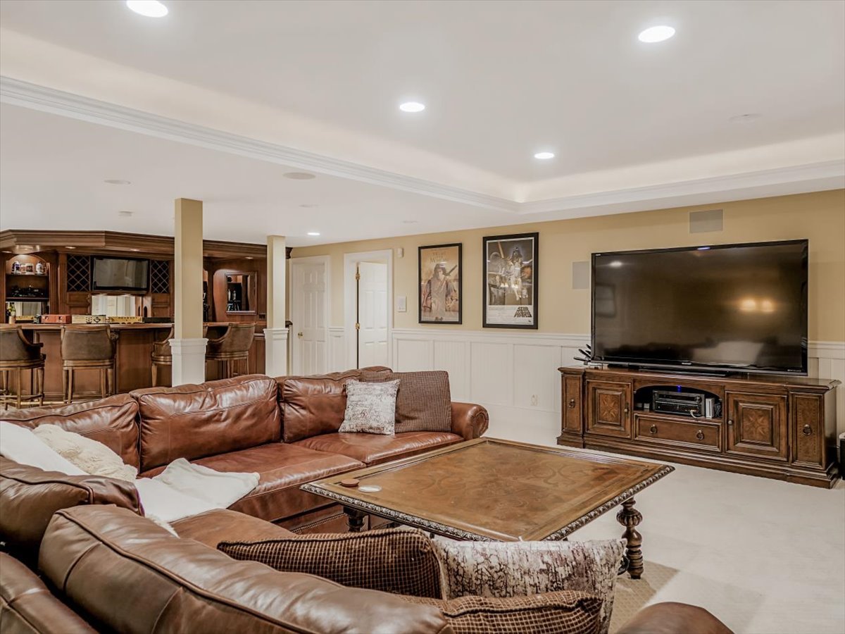 8010 Greenbriar Court Burr Ridge, IL 60527 - Photo 37 of 57 a living room with furniture and a flat screen tv