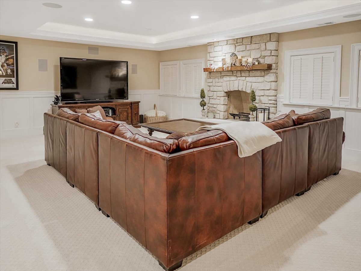 8010 Greenbriar Court Burr Ridge, IL 60527 - Photo 38 of 57 a living room with furniture and a flat screen tv