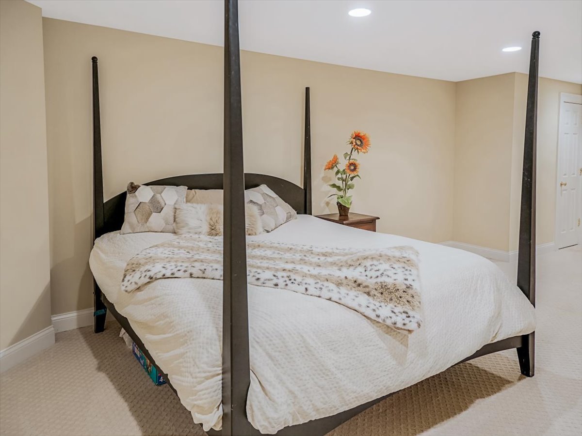 8010 Greenbriar Court Burr Ridge, IL 60527 - Photo 43 of 57 a bedroom with a bed and dresser with mirror