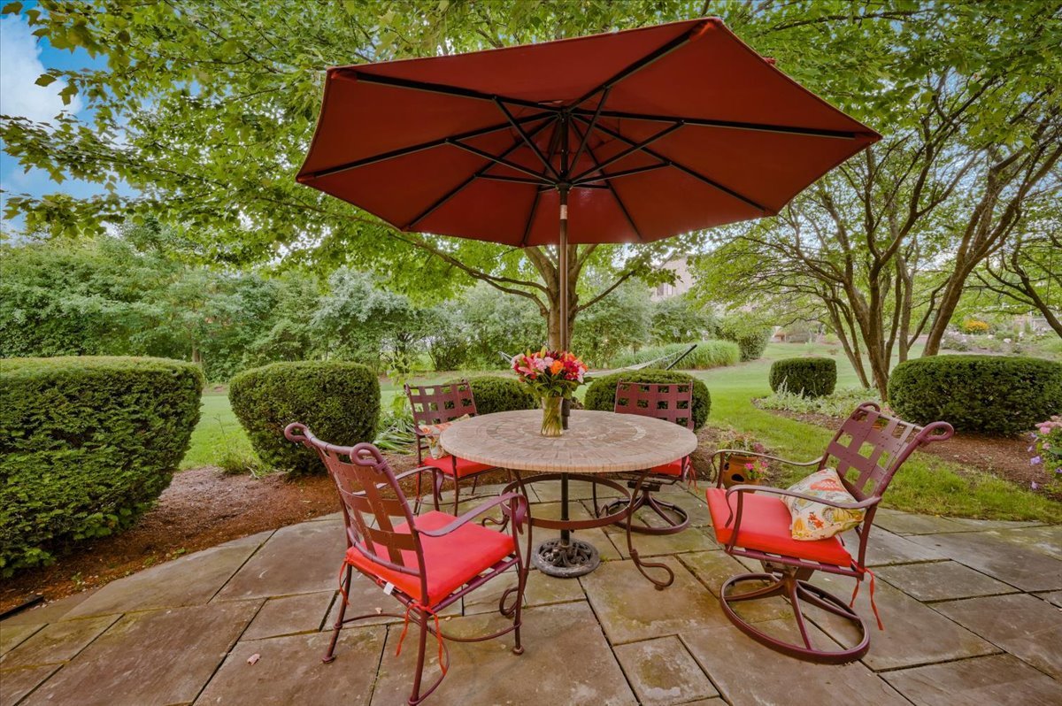 8010 Greenbriar Court Burr Ridge, IL 60527 - Photo 45 of 57 a patio with a table and chairs under an umbrella