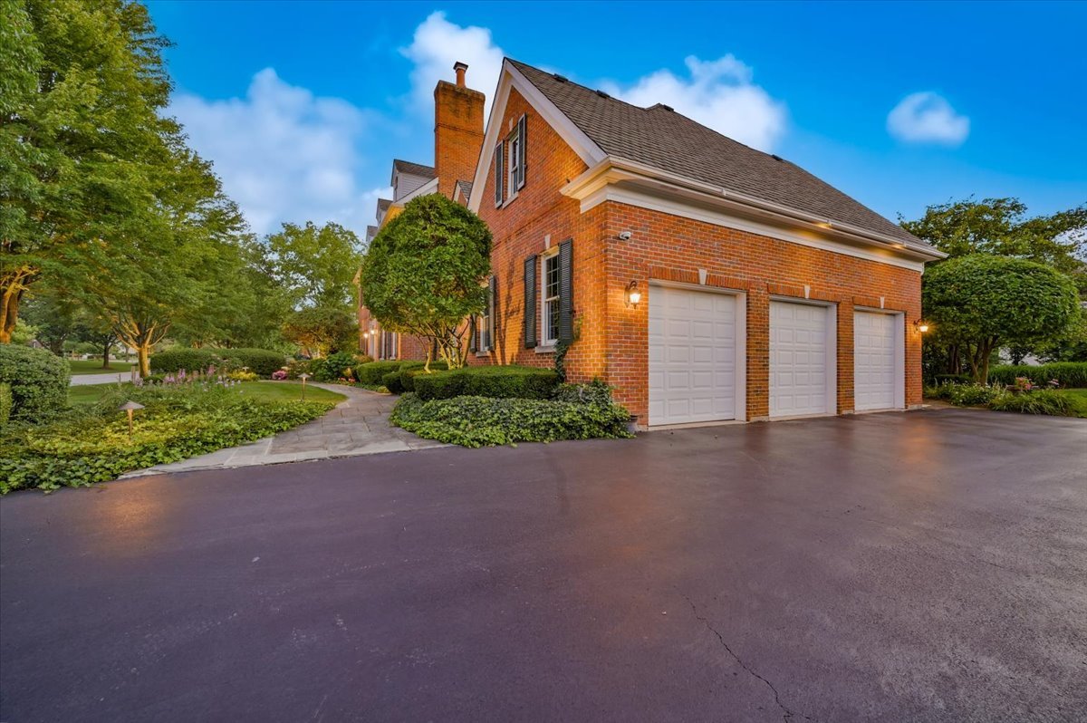8010 Greenbriar Court Burr Ridge, IL 60527 - Photo 49 of 57 a front view of a house with a yard and garage