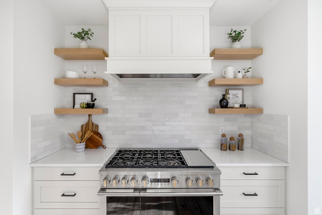 1952 South Comanche Circle Farmington, UT 84025 - Photo 12 of 52 Kitchen with white cabinetry, open shelves, high end stainless steel range oven, and decorative backsplash
