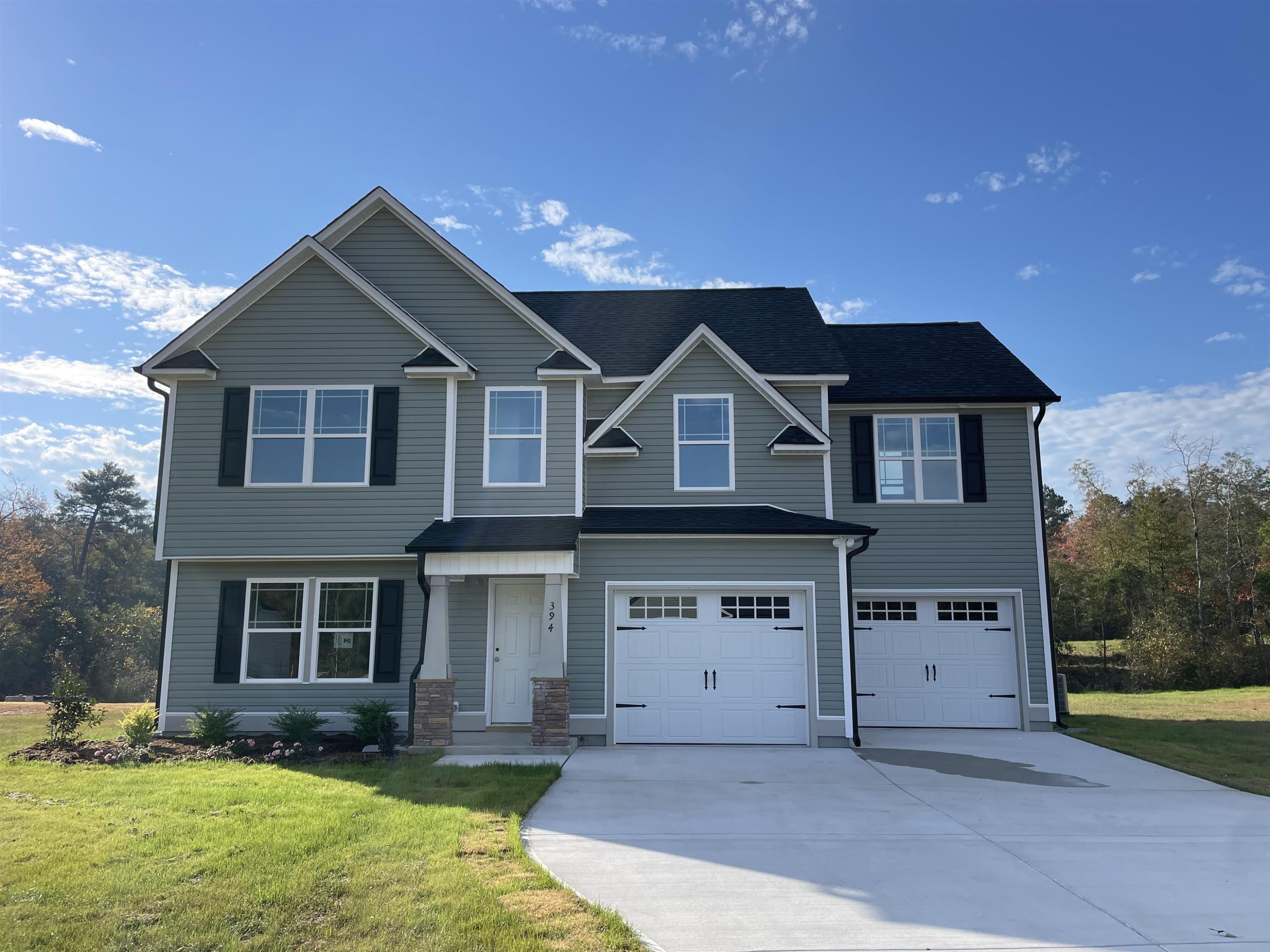 394 Touchdown Way Benson, NC 27504 - Photo 1 of 20 a front view of a house with a yard and garage