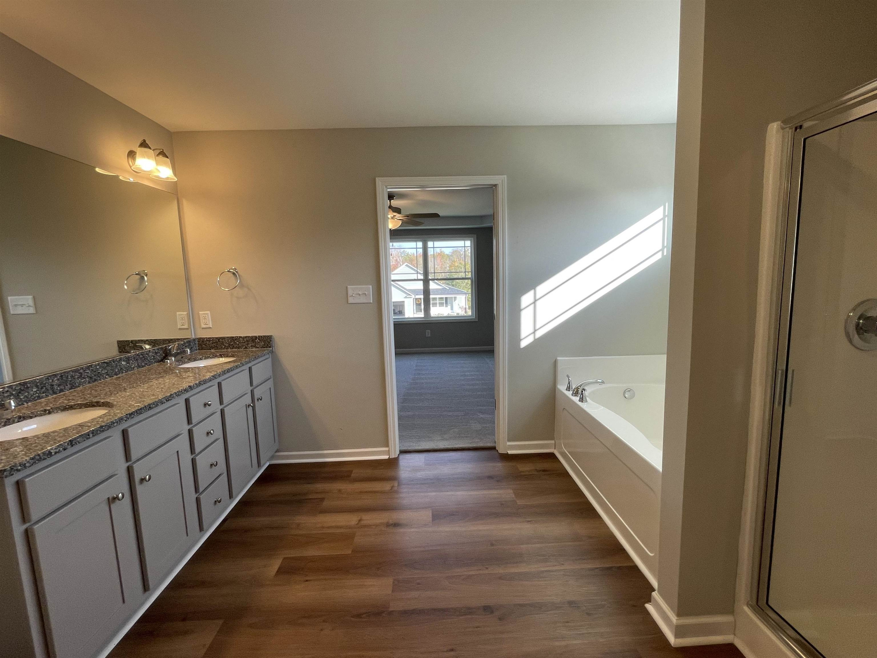 394 Touchdown Way Benson, NC 27504 - Photo 12 of 20 a bathroom with a sink and a large mirror