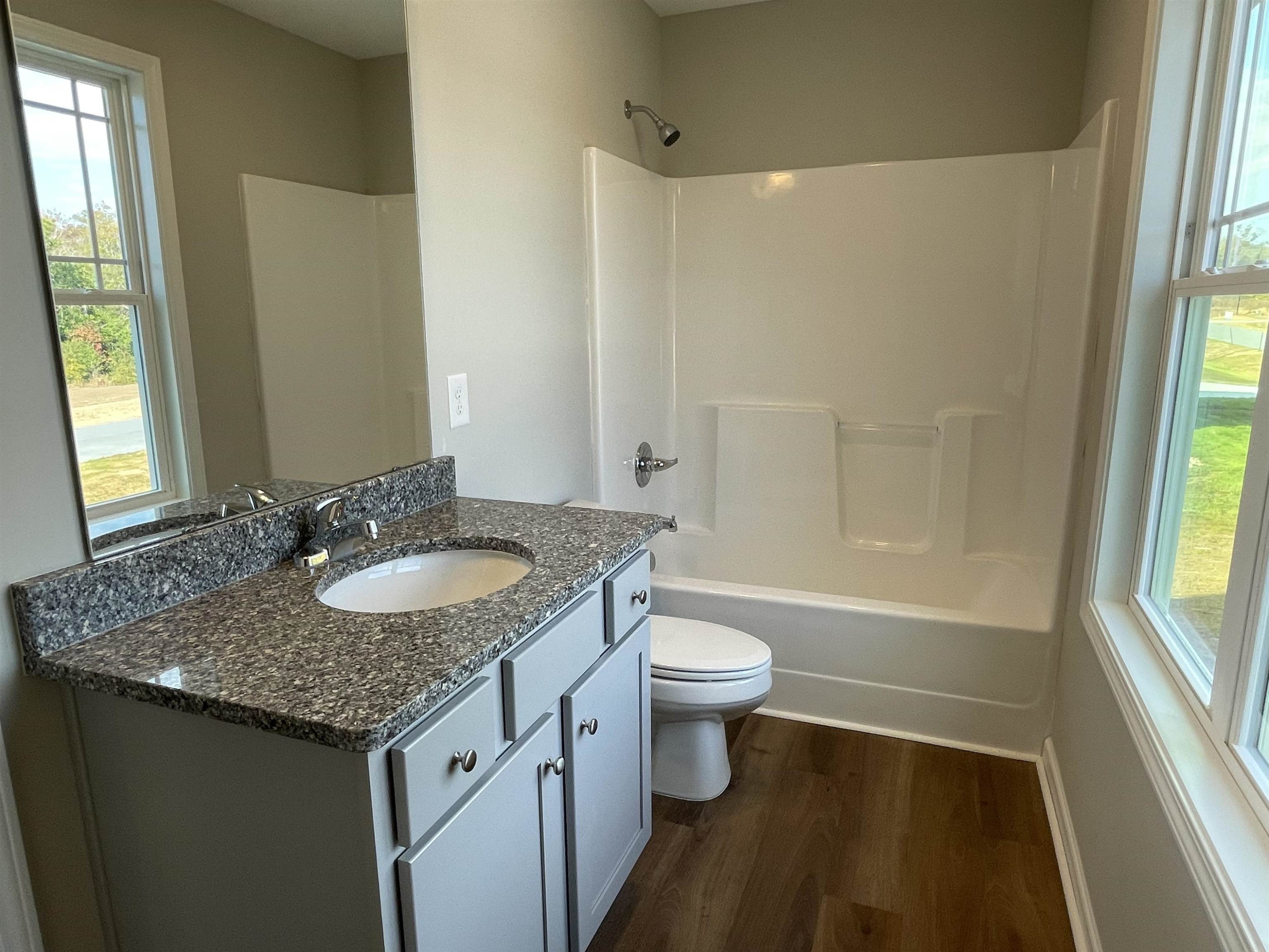 394 Touchdown Way Benson, NC 27504 - Photo 18 of 20 a bathroom with a granite countertop sink and a mirror