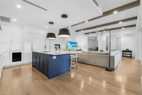 a kitchen with stainless steel appliances kitchen island granite countertop a stove and a sink