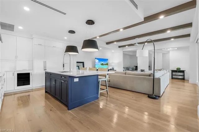 a kitchen with stainless steel appliances kitchen island granite countertop a stove and a sink