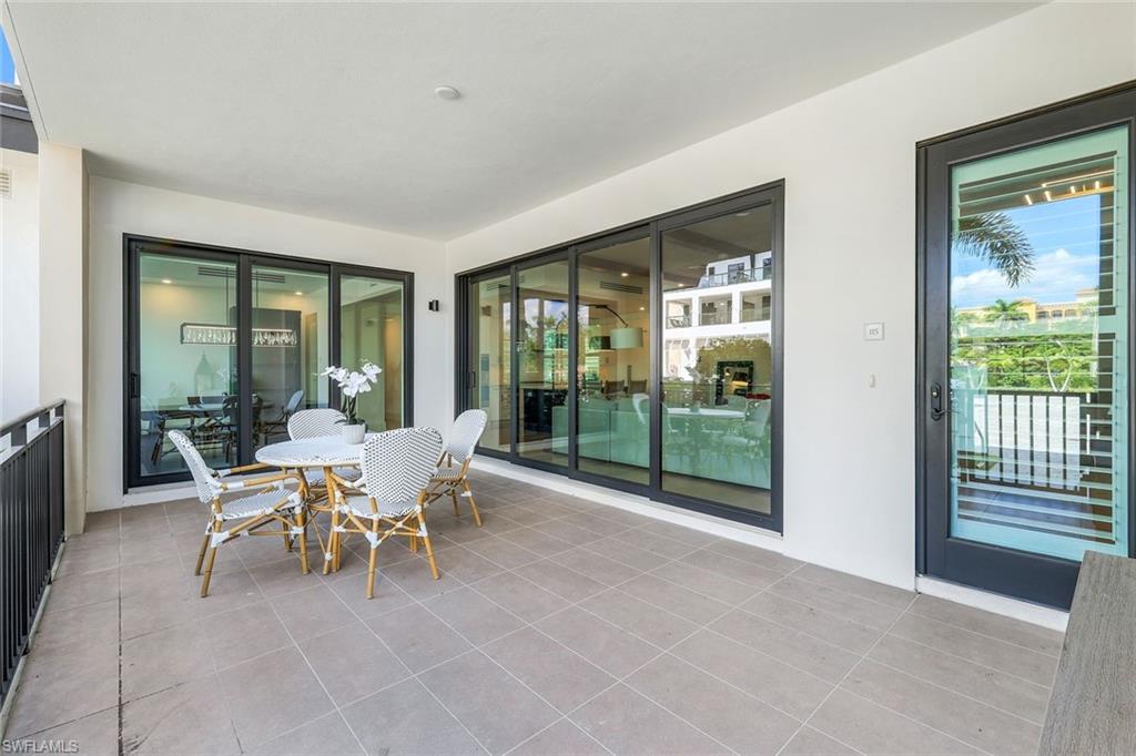1130 3rd Avenue South, Unit 115 Naples, FL 34102 - Photo 16 of 28 a dining room with furniture and large windows