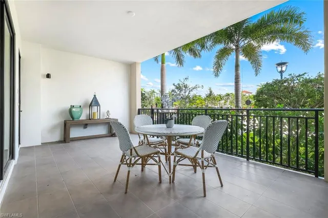 a view of a patio with a table and chairs