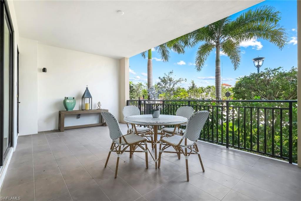 1130 3rd Avenue South, Unit 115 Naples, FL 34102 - Photo 17 of 28 a view of a patio with a table and chairs