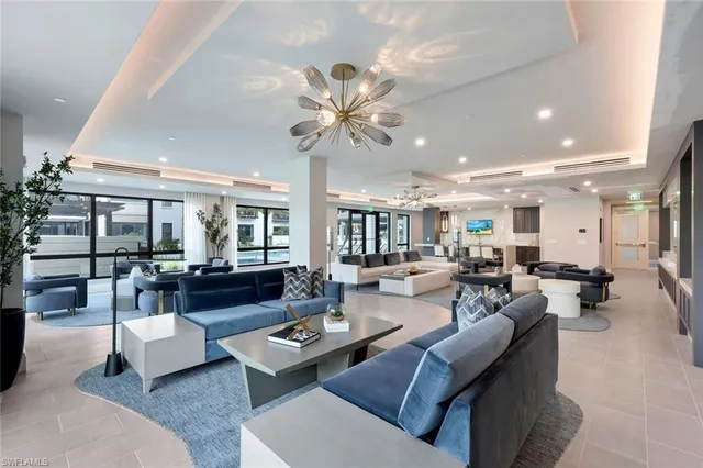 a living room with furniture and view of kitchen