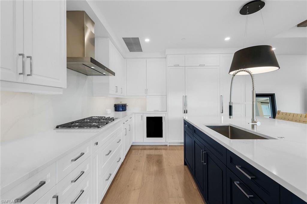 1130 3rd Avenue South, Unit 115 Naples, FL 34102 - Photo 4 of 28 a kitchen with granite countertop a sink and a stove top oven