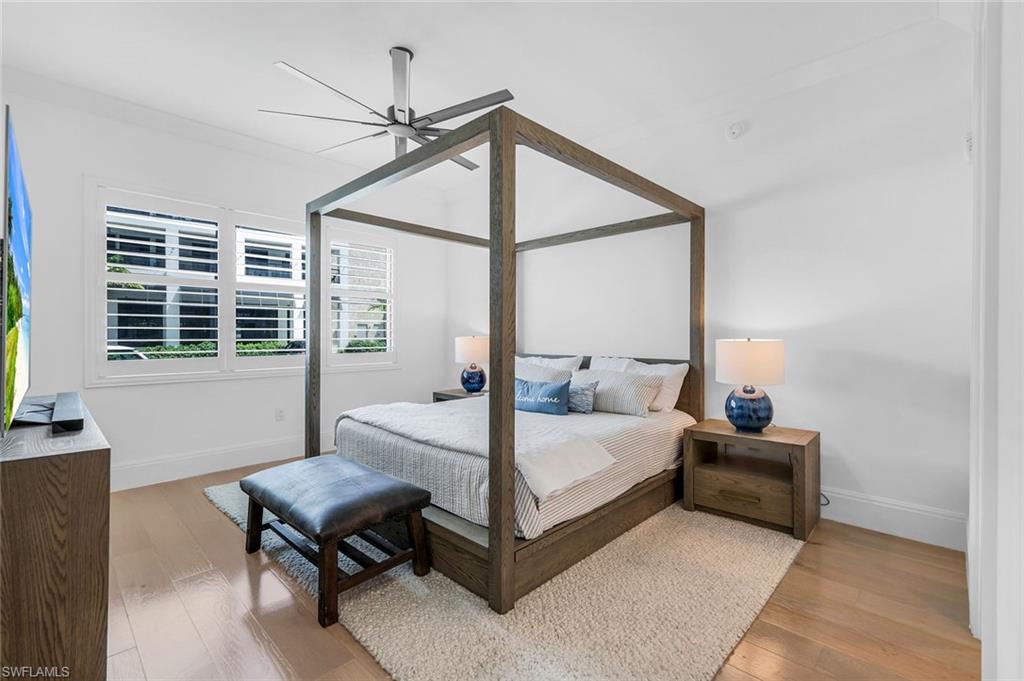1130 3rd Avenue South, Unit 115 Naples, FL 34102 - Photo 10 of 28 a bedroom with a bed window and table
