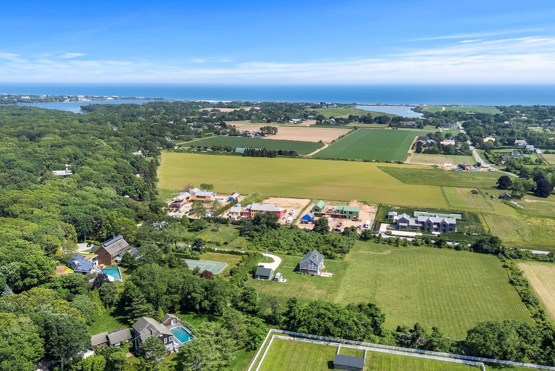 48 Sayre's Path Wainscott, NY 11975 - Photo 7 of 12 Aerial view of property and surrounding area featuring a large body of water, rural landscape, and rows of crops