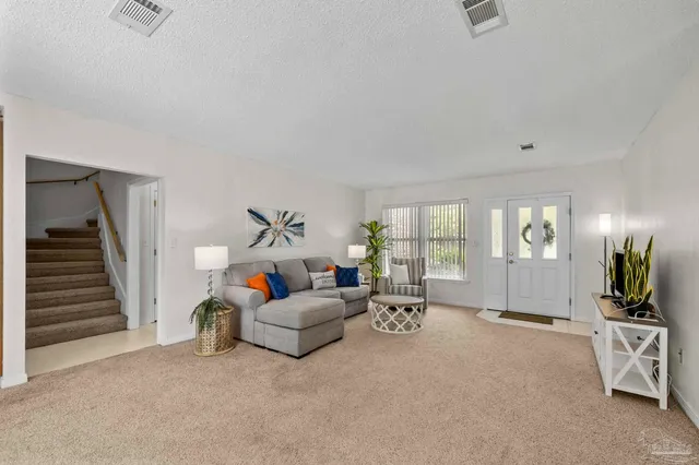 a living room with furniture fireplace and flat screen tv