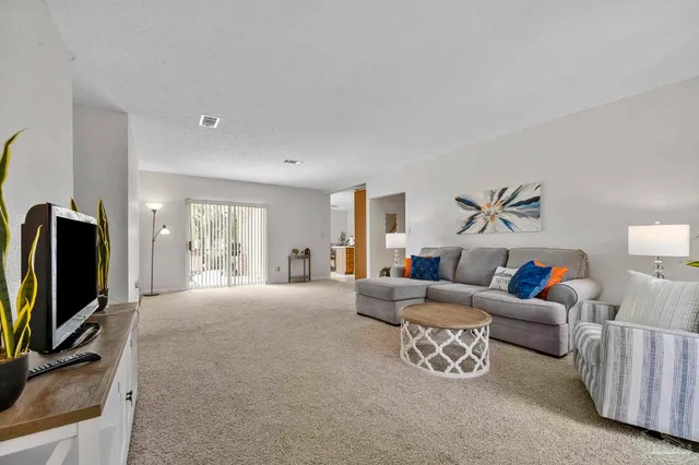 a living room with furniture fireplace and a flat screen tv