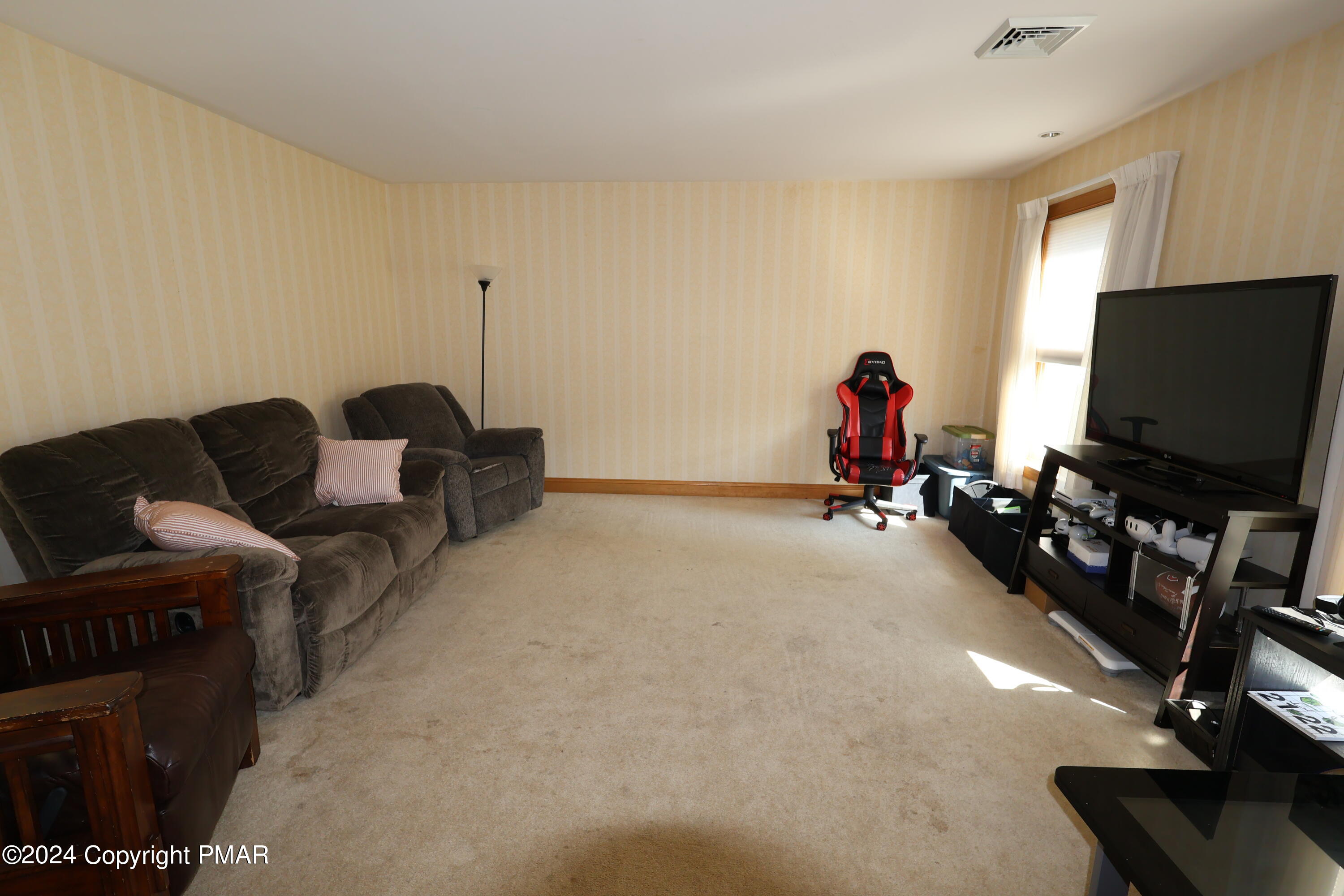 1179 Dotta Drive Pen Argyl, PA 18072 - Photo 20 of 39 a living room with furniture and a flat screen tv
