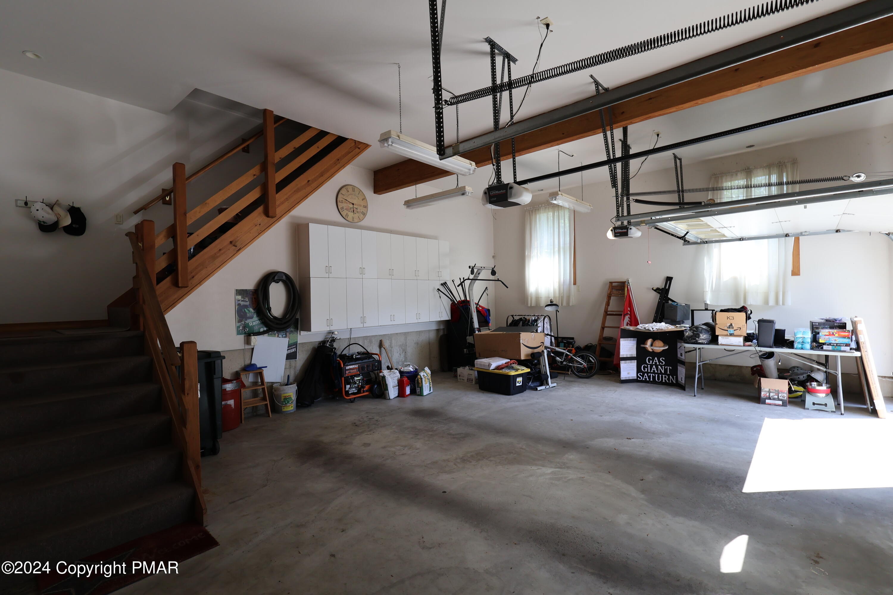 1179 Dotta Drive Pen Argyl, PA 18072 - Photo 38 of 39 a view of a garage with a lot of cars and windows