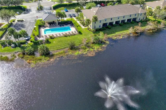 an aerial view of a house with a garden and lake view