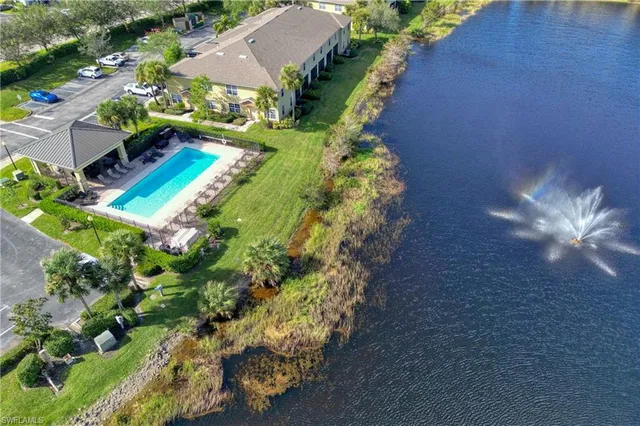 an aerial view of a house with a yard swimming pool outdoor seating