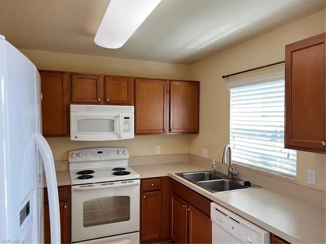 a kitchen with a stove microwave and sink