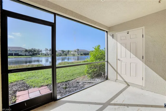 a view of a room with wooden floor and a large window
