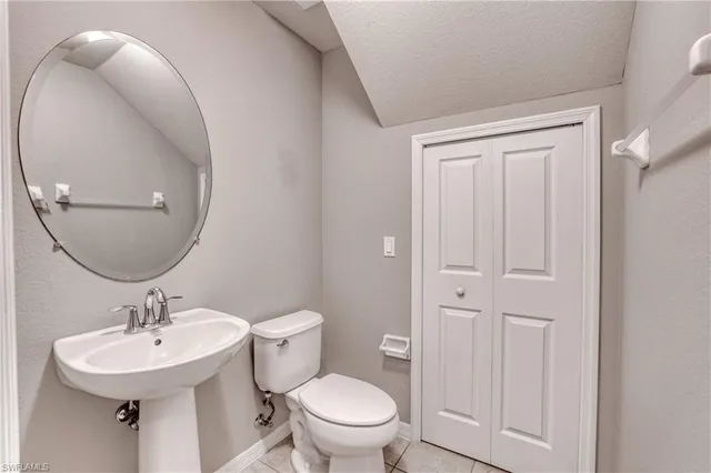 a bathroom with a sink toilet and a mirror