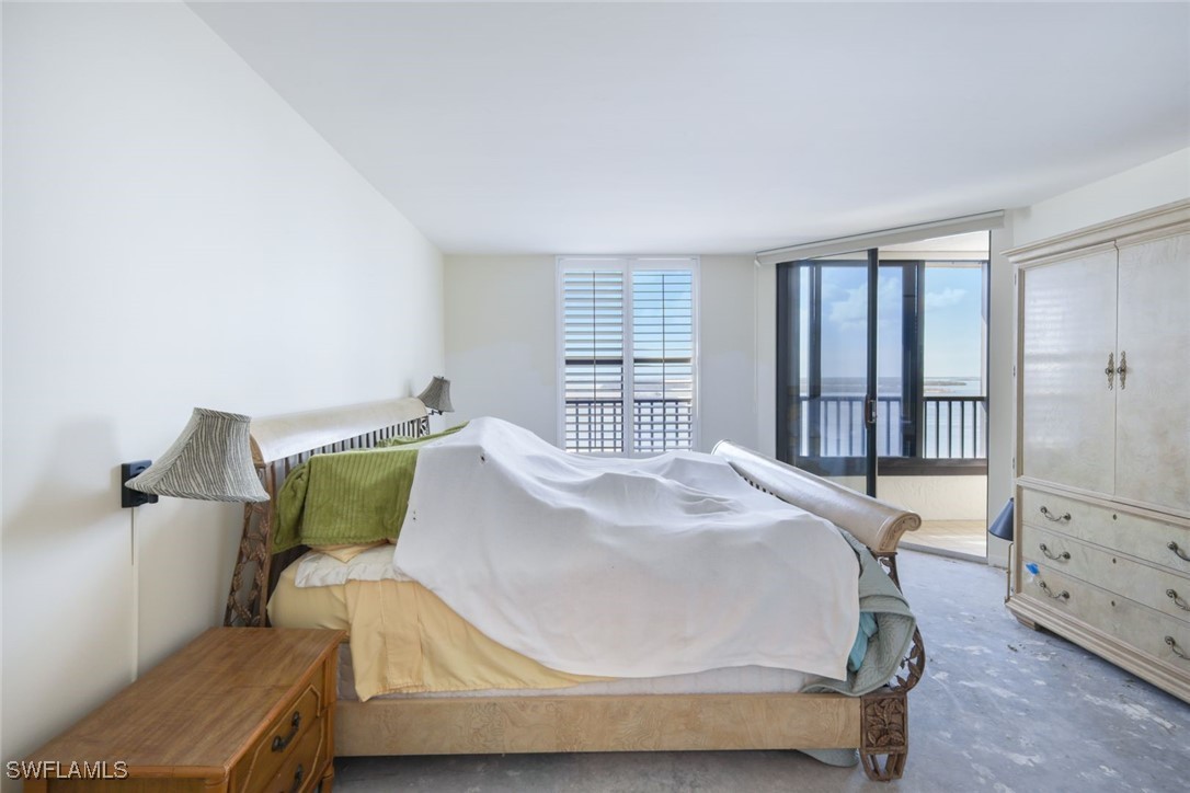 15021 Punta Rassa Road, Unit 902 Fort Myers, FL 33908 - Photo 13 of 31 a bed sitting in a bedroom next to a window