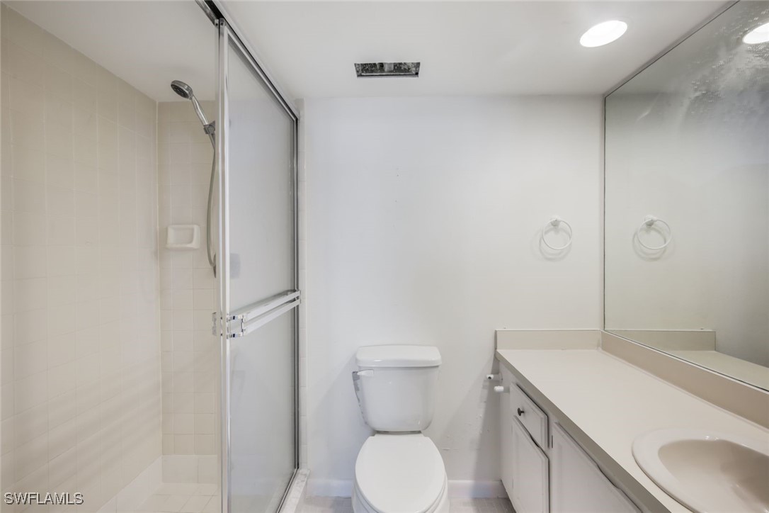 15021 Punta Rassa Road, Unit 902 Fort Myers, FL 33908 - Photo 15 of 31 a bathroom with a granite countertop sink toilet and shower