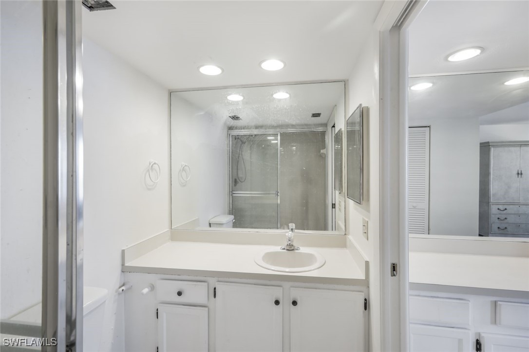15021 Punta Rassa Road, Unit 902 Fort Myers, FL 33908 - Photo 17 of 31 a bathroom with a sink shower and a mirror