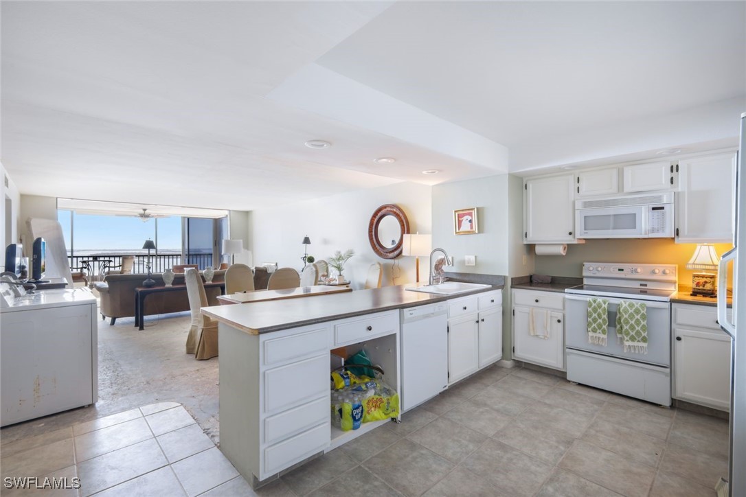 15021 Punta Rassa Road, Unit 902 Fort Myers, FL 33908 - Photo 6 of 31 a kitchen with a sink stove and cabinets