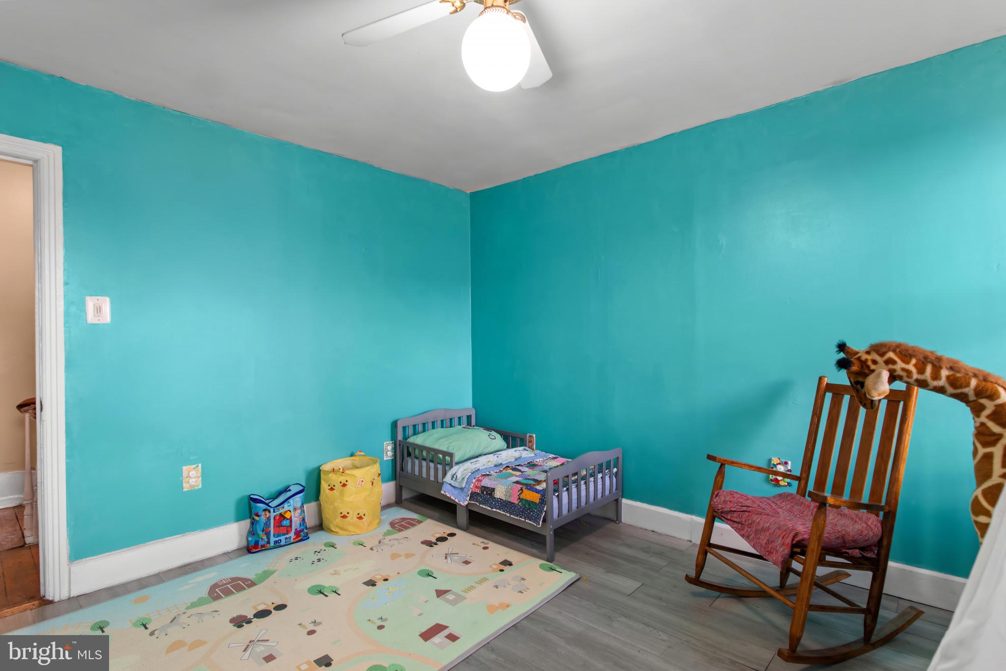 702 West Main Street Waynesboro, PA 17268 - Photo 22 of 32 a bedroom with a bed and wooden floor
