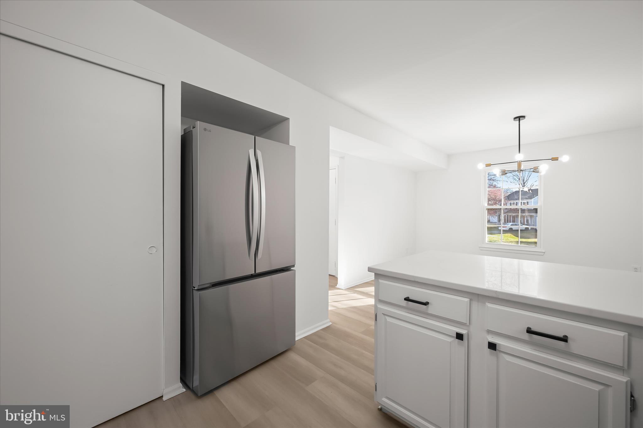 9344 Spring Water Path Jessup, MD 20794 - Photo 16 of 61 a kitchen with a refrigerator and a sink