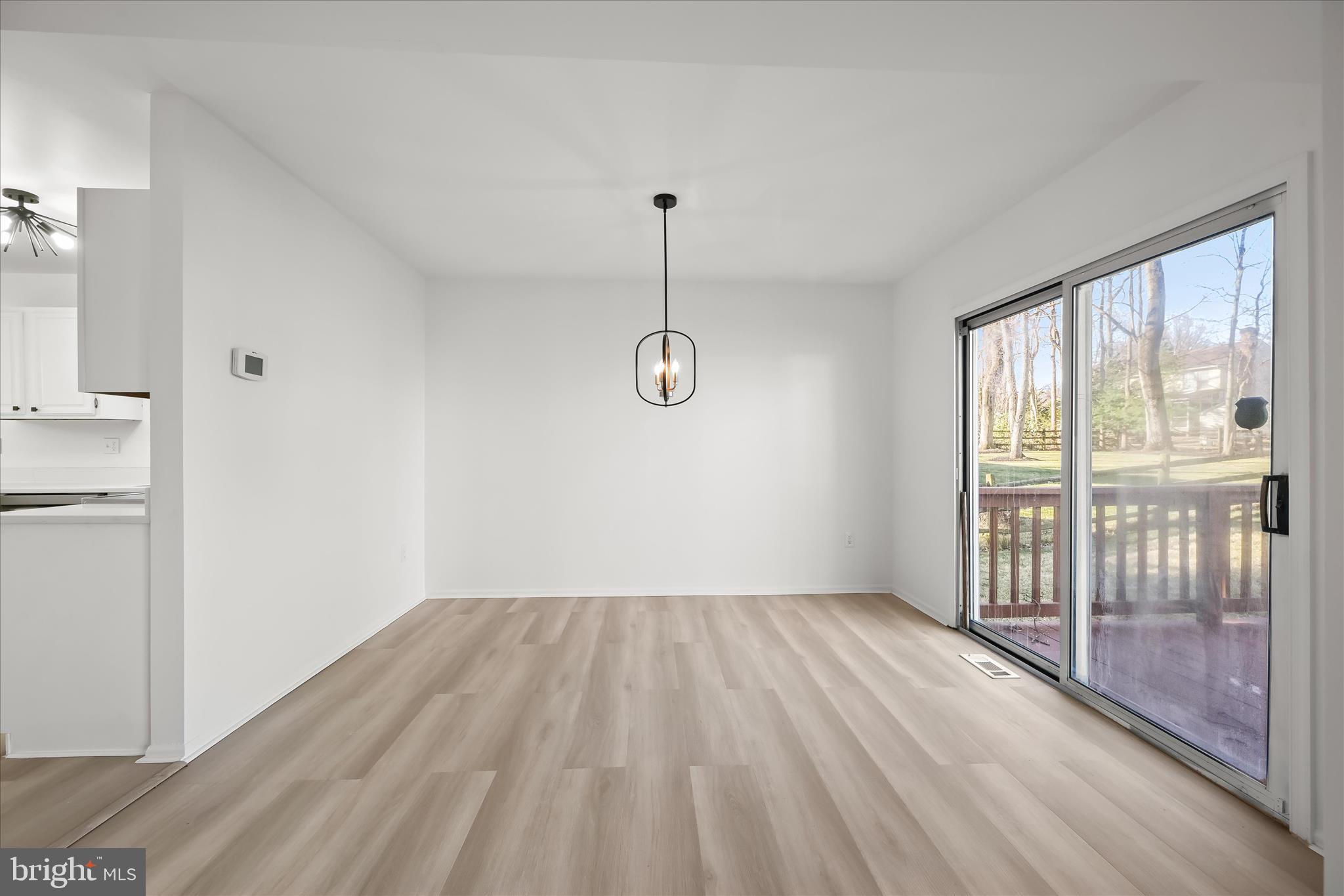 9344 Spring Water Path Jessup, MD 20794 - Photo 18 of 61 a view of empty room with wooden floor and fan