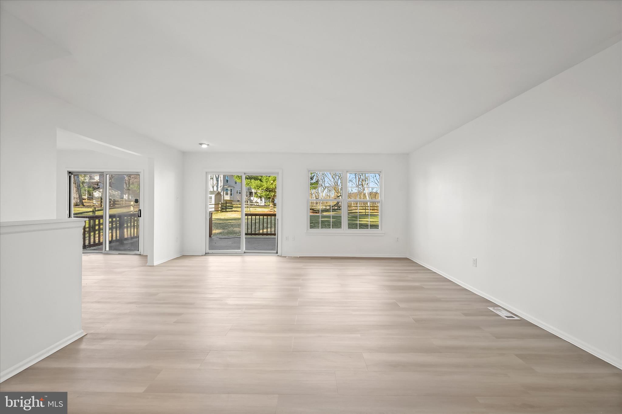 9344 Spring Water Path Jessup, MD 20794 - Photo 23 of 61 an empty room with wooden floor and windows