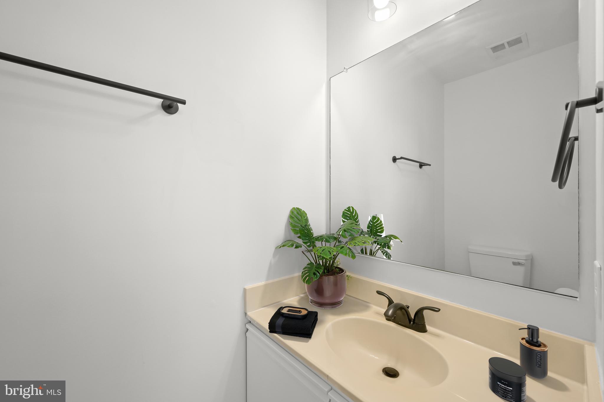 9344 Spring Water Path Jessup, MD 20794 - Photo 29 of 61 a bathroom with a sink a shower and a mirror