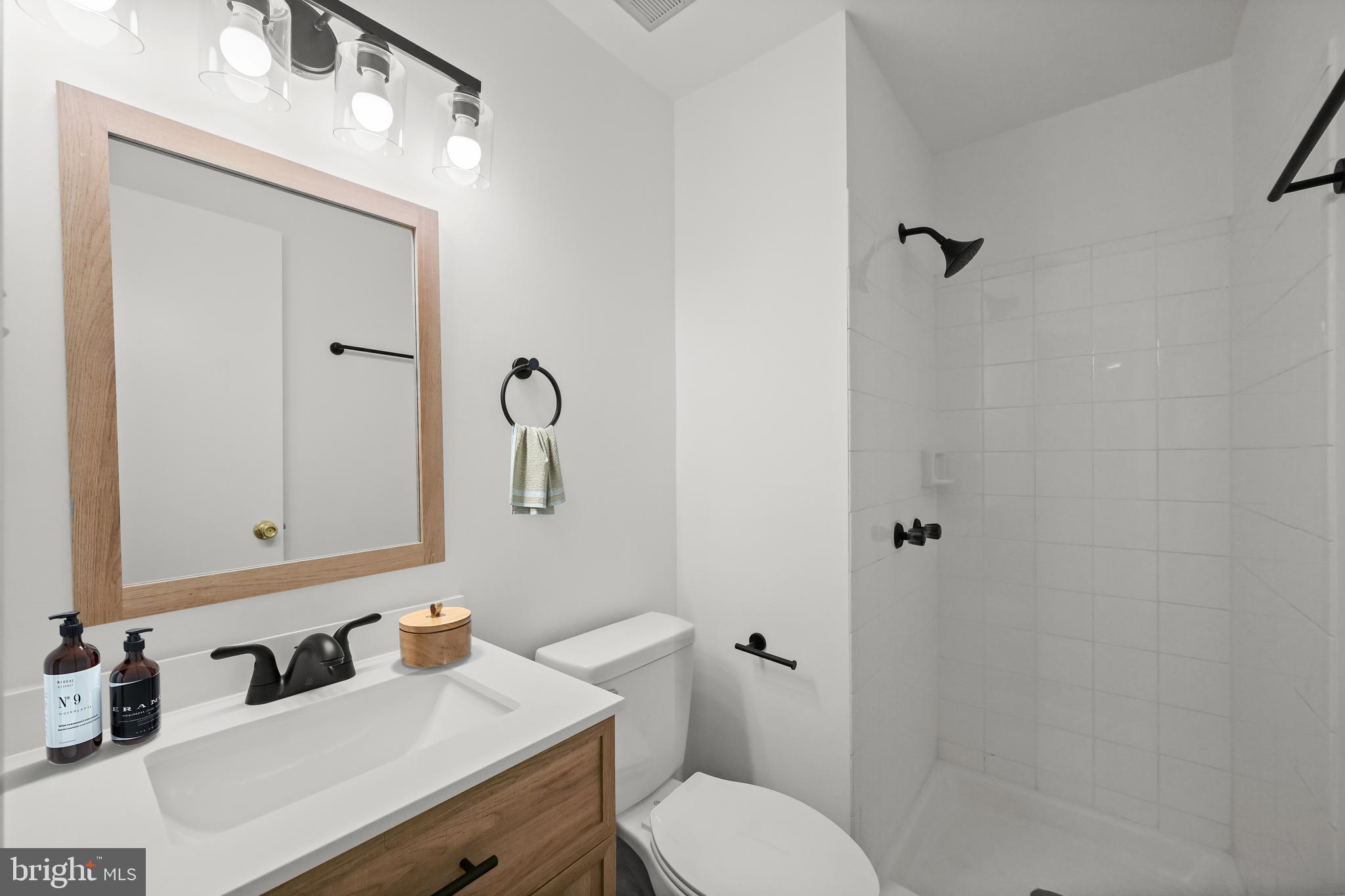 9344 Spring Water Path Jessup, MD 20794 - Photo 52 of 61 a bathroom with a toilet sink vanity and mirror