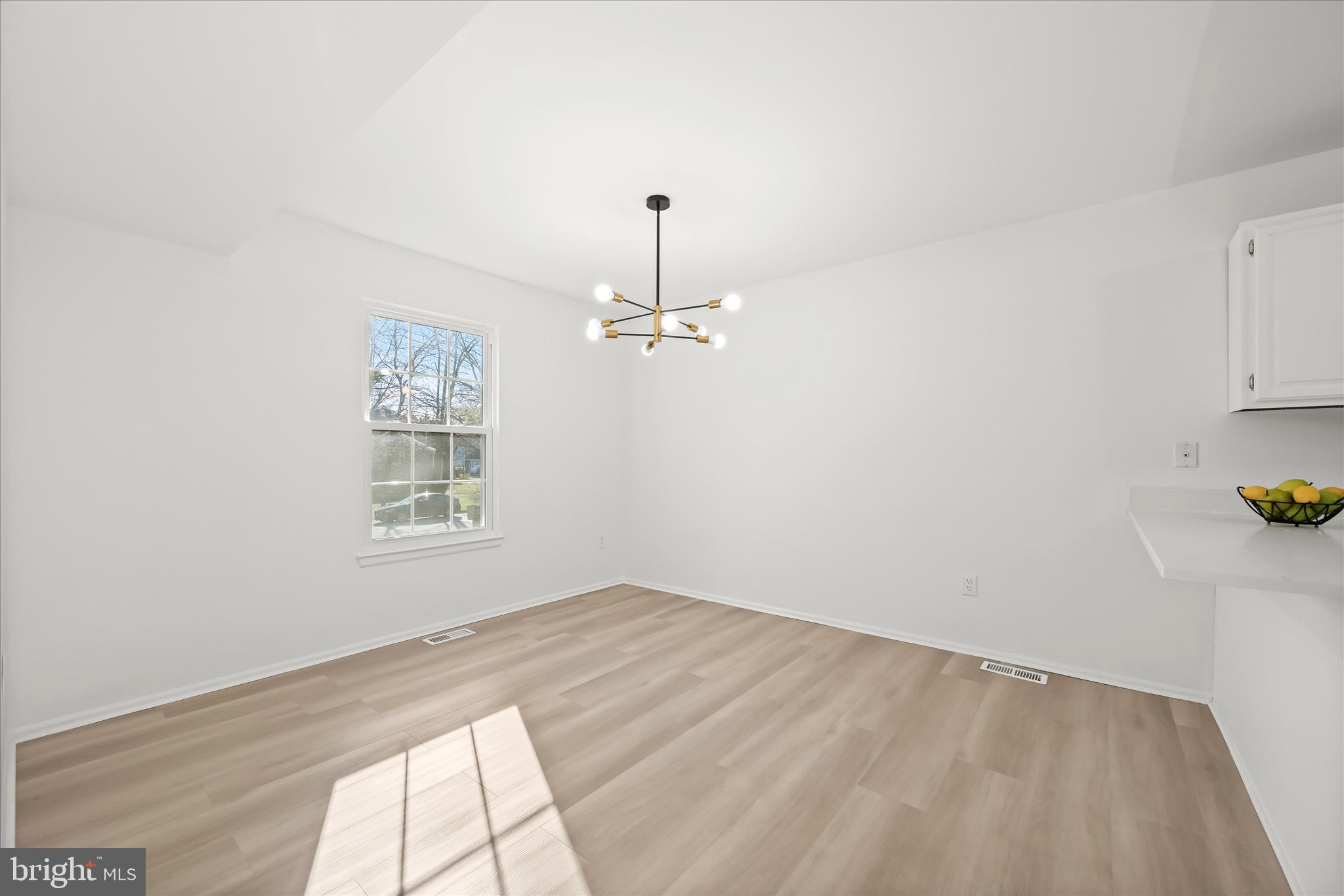 9344 Spring Water Path Jessup, MD 20794 - Photo 10 of 61 an empty room with windows and cabinet