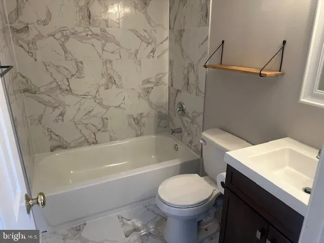 a bathroom with a sink toilet and bathtub